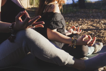 crop-mother-daughter-meditating-park.jpg